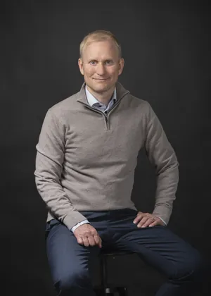 Seated portrait in a sweater, vertical: Samppa Lajunen